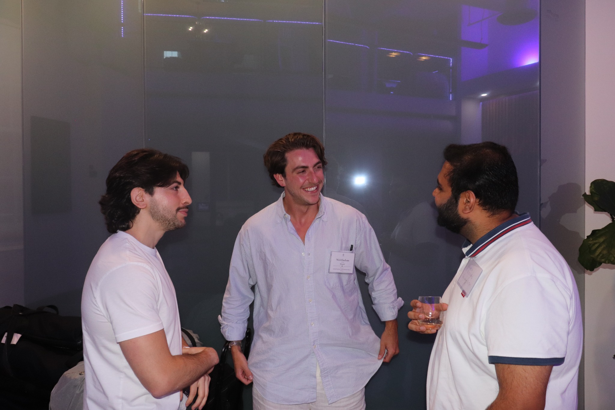 Three guests in conversation at a technology event