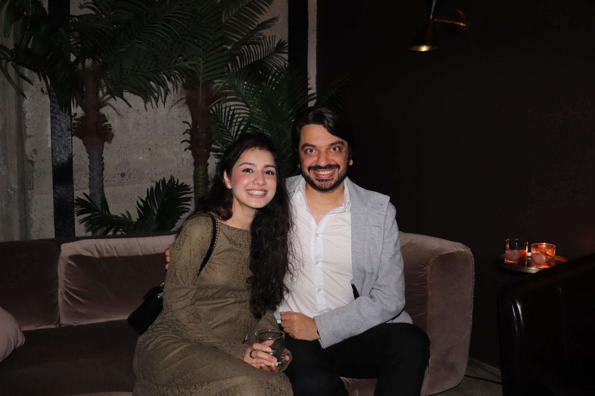 Two guests posing together at an evening event