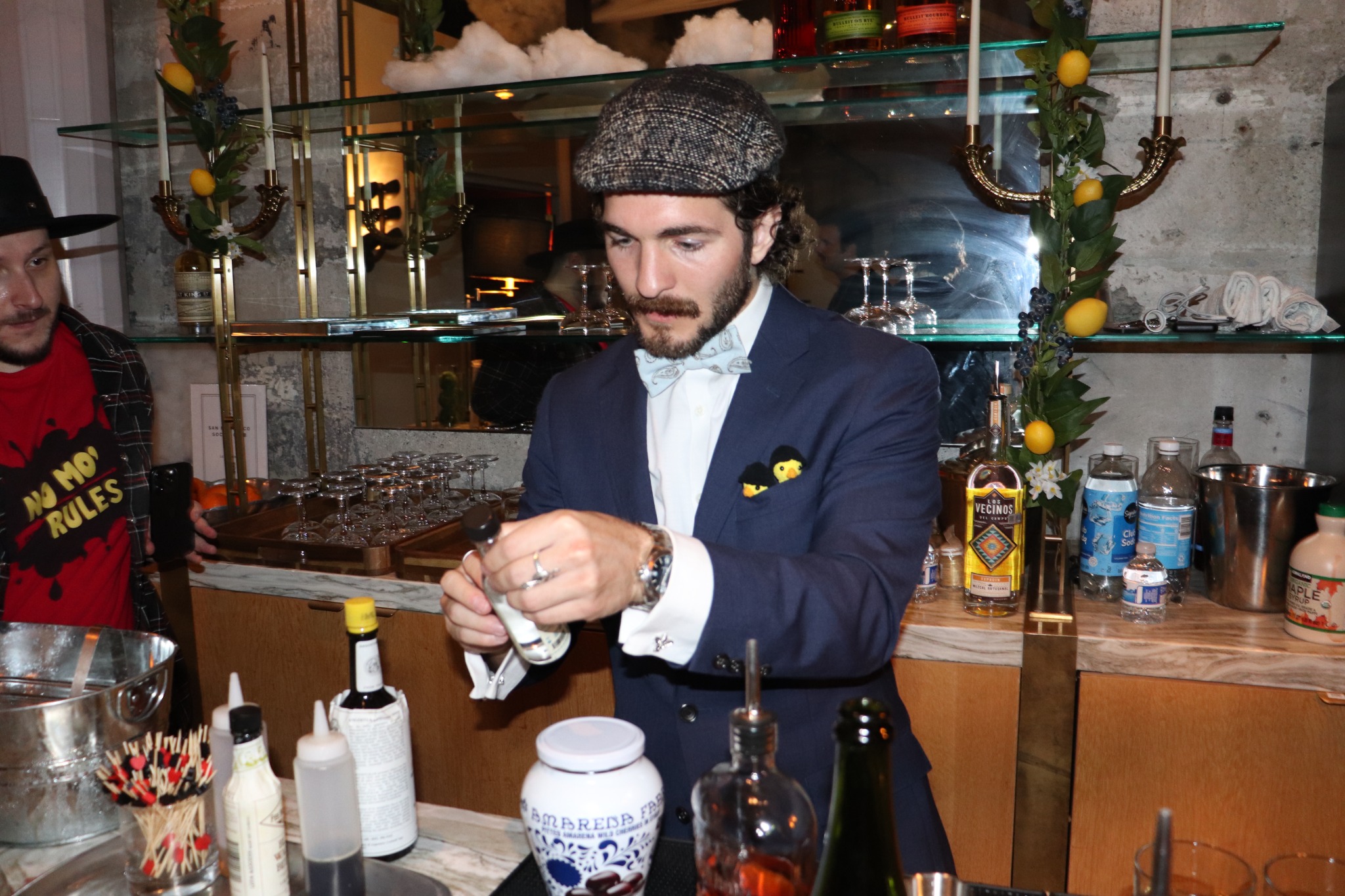 A guest preparing a drink behind the bar